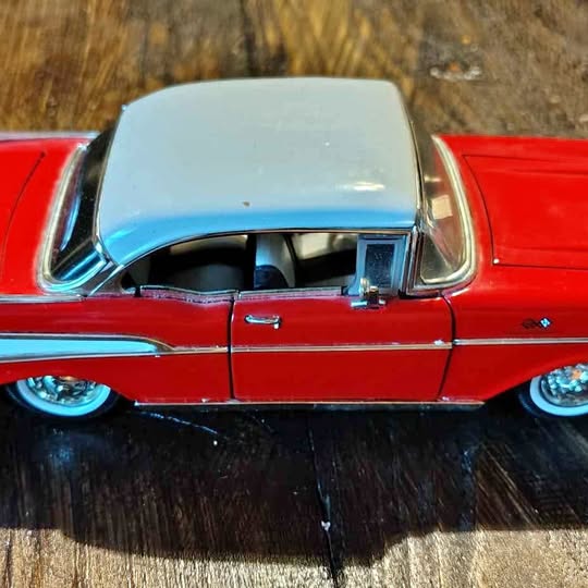 Red diecast 1957 Chevrolet Bel Air model car, front side with chrome grille