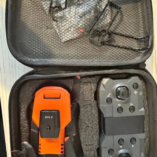 Drone kit in case: orange remote controller and gray drone body