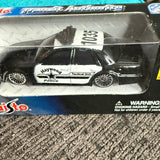 Diecast police tactical unit toy car in black and white with graphics, boxed