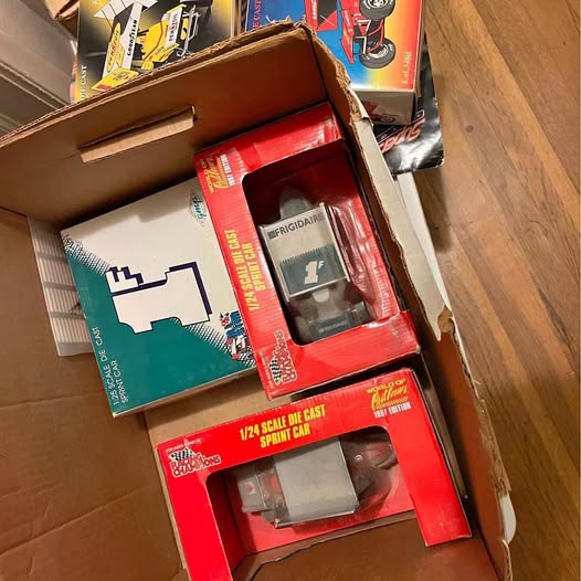 Boxed 1:24 sprint car diecast models, red and teal packaging