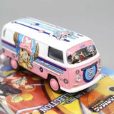 Pink and white diecast VW T1 van bus model toy with cartoon decals, front 3/4 view