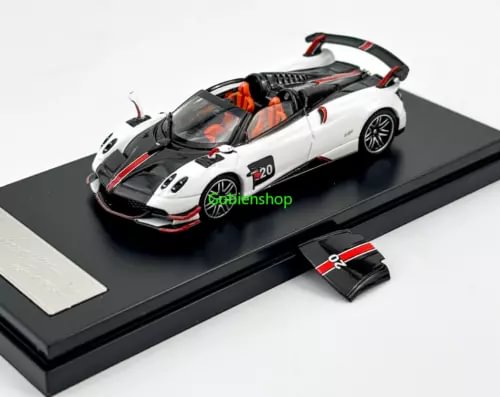 White sports diecast car model with orange details on display base, front view