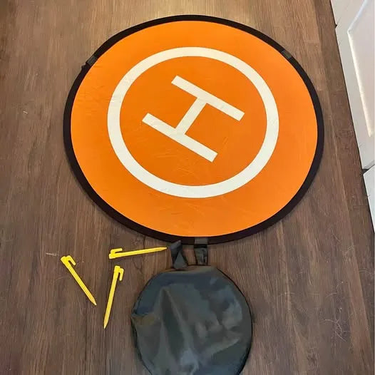 Drone landing pad, orange circular mat with white crosshair airplane icon; includes dark pouch