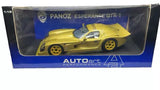 Metallic gold diecast sports car model with yellow wheels in display box