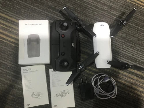 DJI Spark drone with white controller, battery, and cables