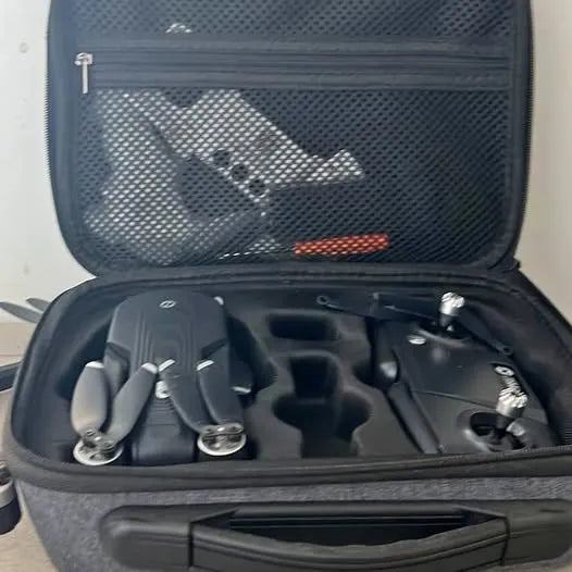Open drone carrying case with foam inserts and mounted drone components