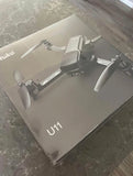White quadcopter drone with four propellers on U11S packaging box
