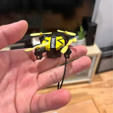 Mini quadcopter drone with yellow and black frame and four yellow propellers