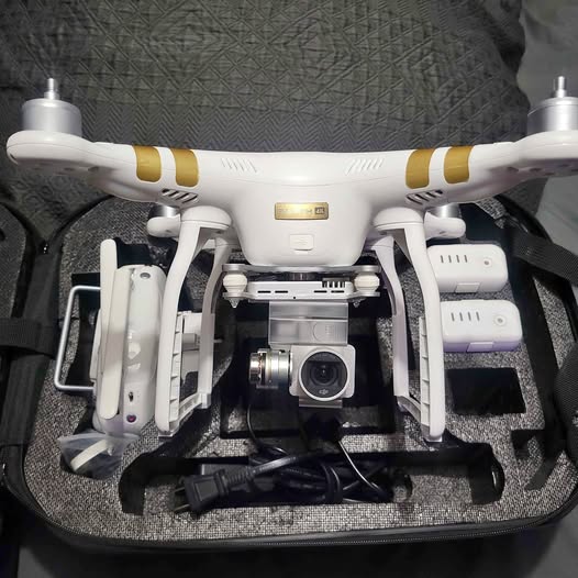 White quadcopter drone with front camera and gimbal, propellers visible