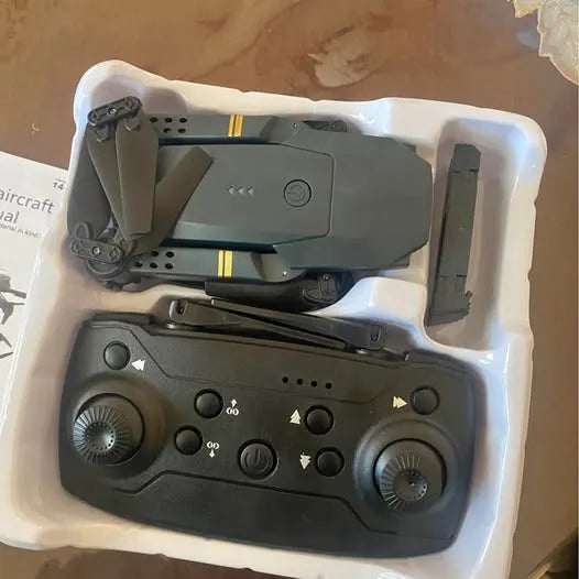Gray drone with remote controller in foam insert