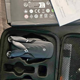Gray 4K camera drone lying in a molded carrying case