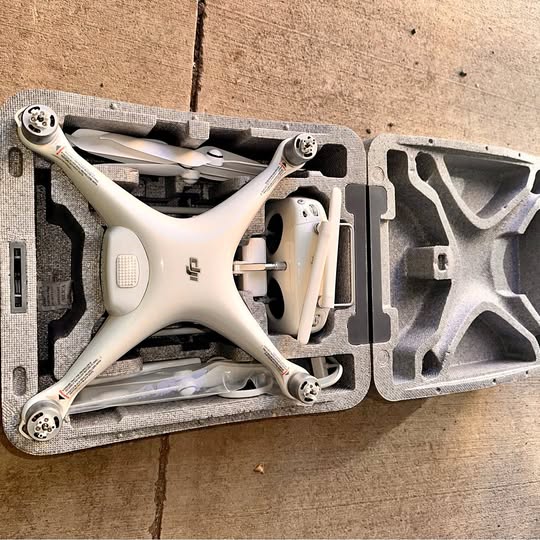DJI Phantom 4 Pro drone in foam case, white four-arm body