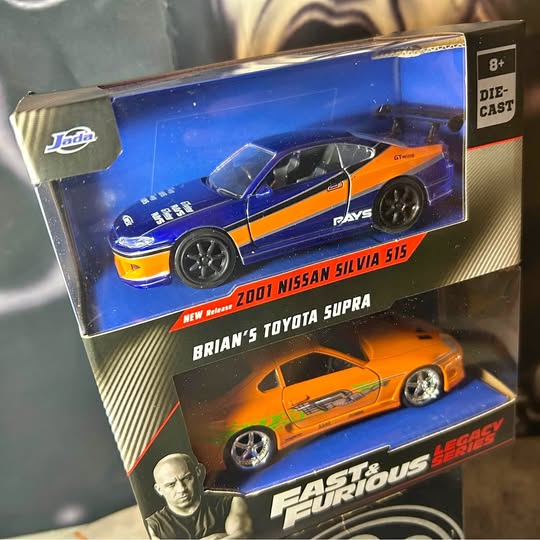 Diecast car double pack in retail box, featuring blue and orange racing cars.