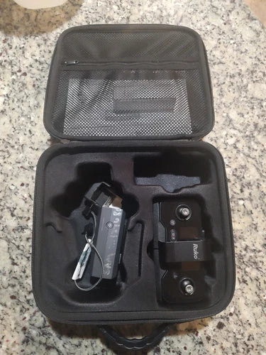 Drone case open with Ruko charger, remote, and cables in molded foam