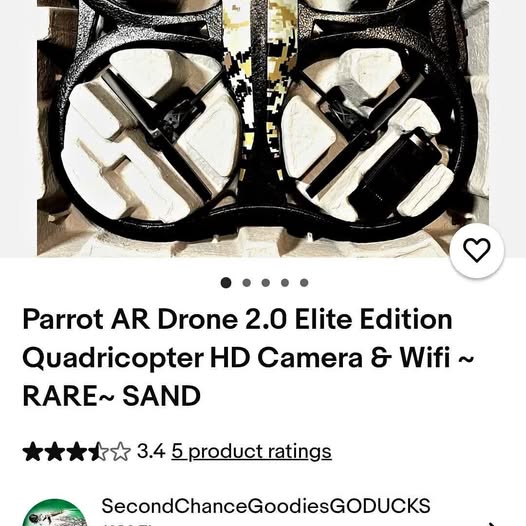 Quadcopter drone with black propeller guards and white propeller blades, close-up