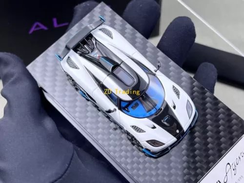 1:64 white racing sports diecast model car with blue accents, on carbon-fiber base