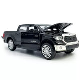 Black diecast pickup truck toy with open door and raised hood
