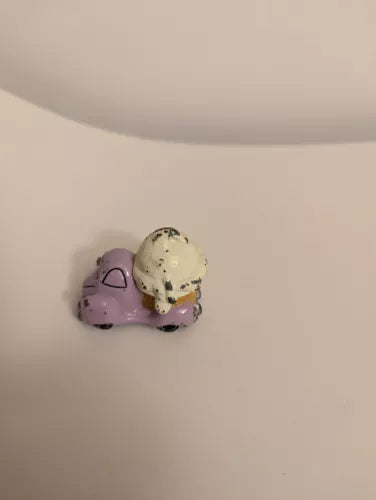 Diecast ice cream truck toy with two purple scoops and a beige scoop on top