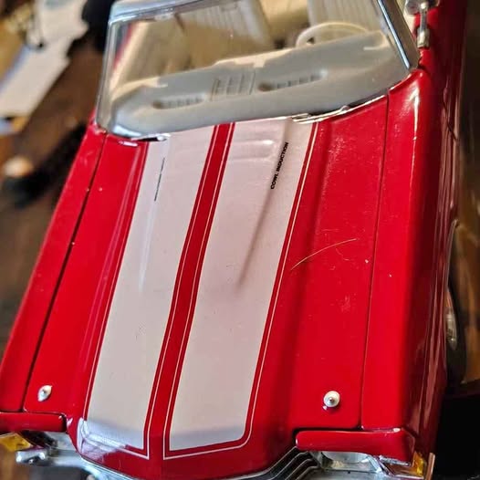 Red and white striped diecast muscle car hood with front grille detail