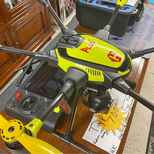 Yuneec Typhoon H drone with lime yellow and black body, quad propellers and folded arms