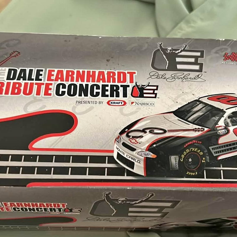 Nascar diecast stock car with white body, red accents, black details, on display