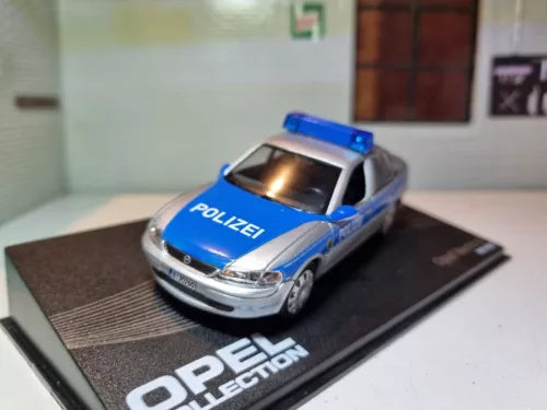 Blue and silver Polizei diecast police car with roof light bar