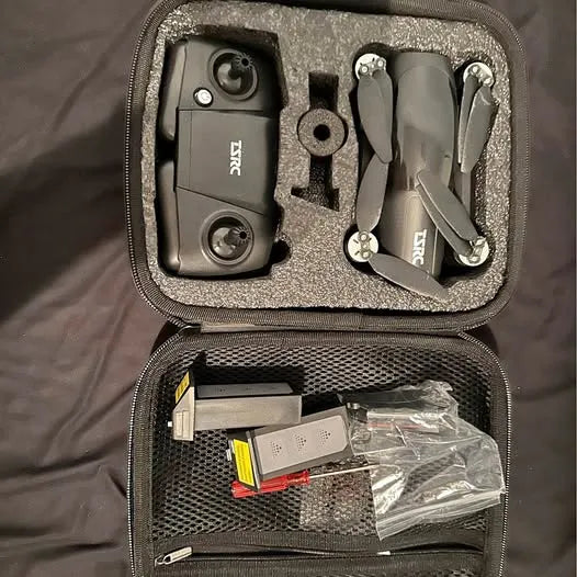 Zippered drone accessory case with two compact devices, cables, and spare parts