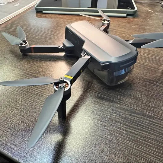 Snaptain P30 Garland TX drone with four gray propellers, folded arms visible