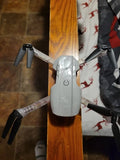 Light gray foldable quadcopter drone with four propellers