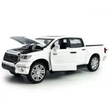 White diecast pickup truck model car with open hood, front 3/4 view and chrome wheels