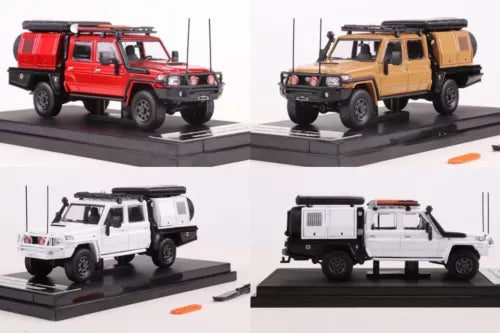 Diecast metal pickup truck models in red, yellow, and white on display bases