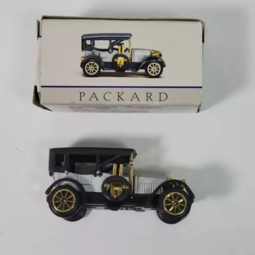 Packard diecast model car with gold details and wheels, shown with open box