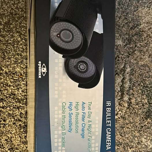 Dual black bullet cameras with two circular lenses on a mounting bracket