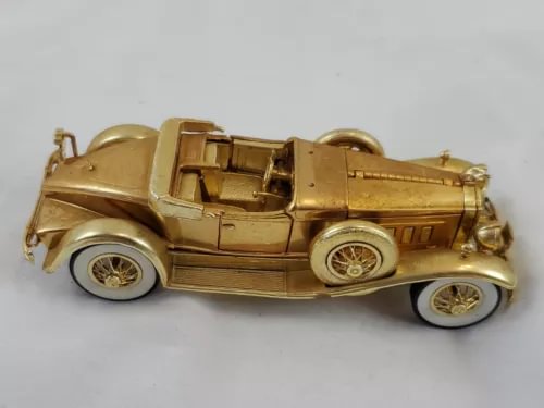 Gold 1930 Packard convertible diecast car, 1:32 scale, detailed wheels.