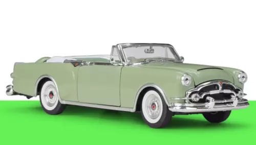 Pale green diecast convertible sports car model with chrome details and whitewall tires