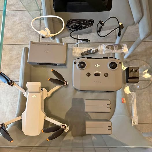 Compact drone accessories kit with drone body, extra batteries, and propellers