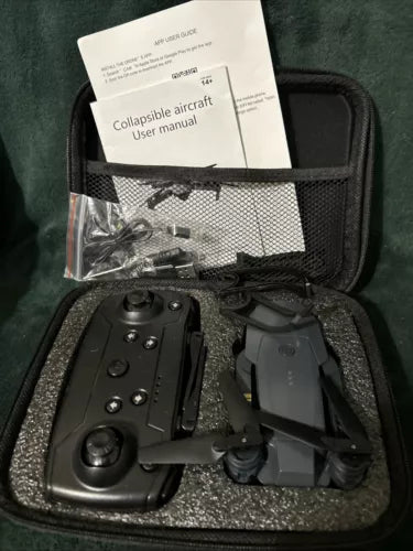 Collapsible quadcopter drone with remote controller and spare parts in black case