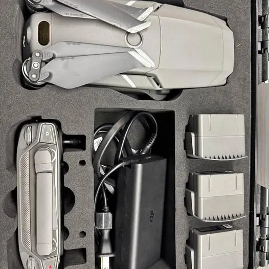 Grey flying drone remote controller and accessory case insert with cables and battery bays
