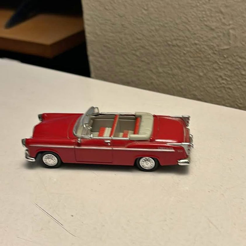 Red 1955 convertible diecast car, side view with chrome details and open cabin