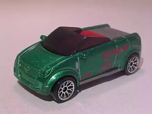 Green Opel Frogster diecast car with red interior detail, mint loose 1/64 scale