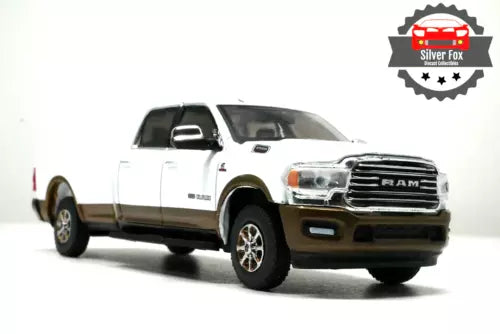 White diecast pickup truck model with chrome grille and front headlights, front 3/4 view
