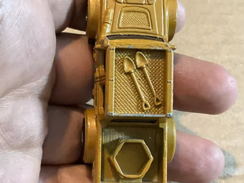 Tan diecast battle mission truck, front grille and cab detail close-up