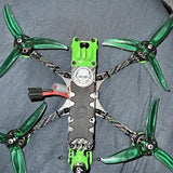 FPV drone with green propellers and black frame, top view