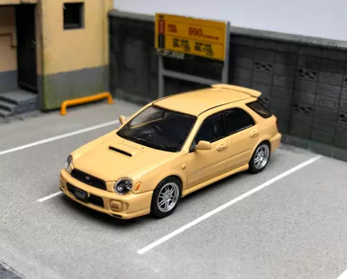 Yellow diecast wagon model car with front 3/4 view and white wheels
