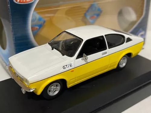 Yellow and white Opel Kadett GTE 1977 diecast model car on display base