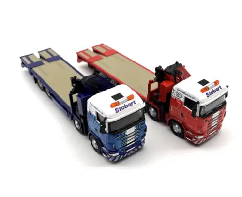 Diecast toy flatbed tow truck model set with blue and red cabs and trailer