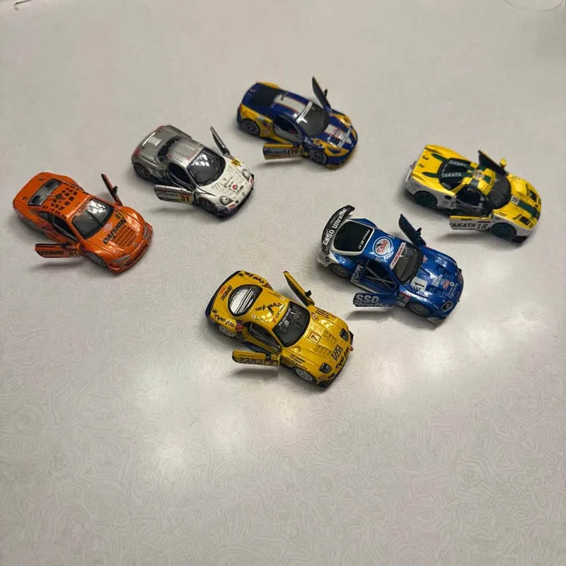Diecast race cars, assorted colors and designs, arranged in a top view