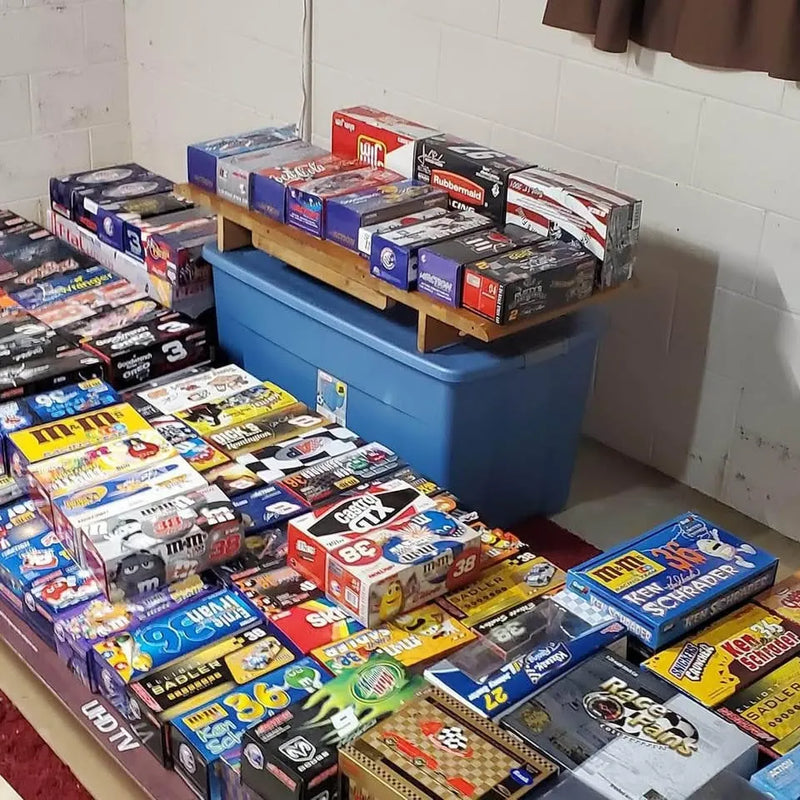 Racing diecast model boxes collection displayed on store shelves