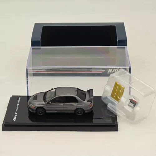 Gray 1/64 diecast model car with clear display case and box stand