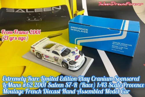 White race car diecast model with blue sponsor decals, detailed front and side view.